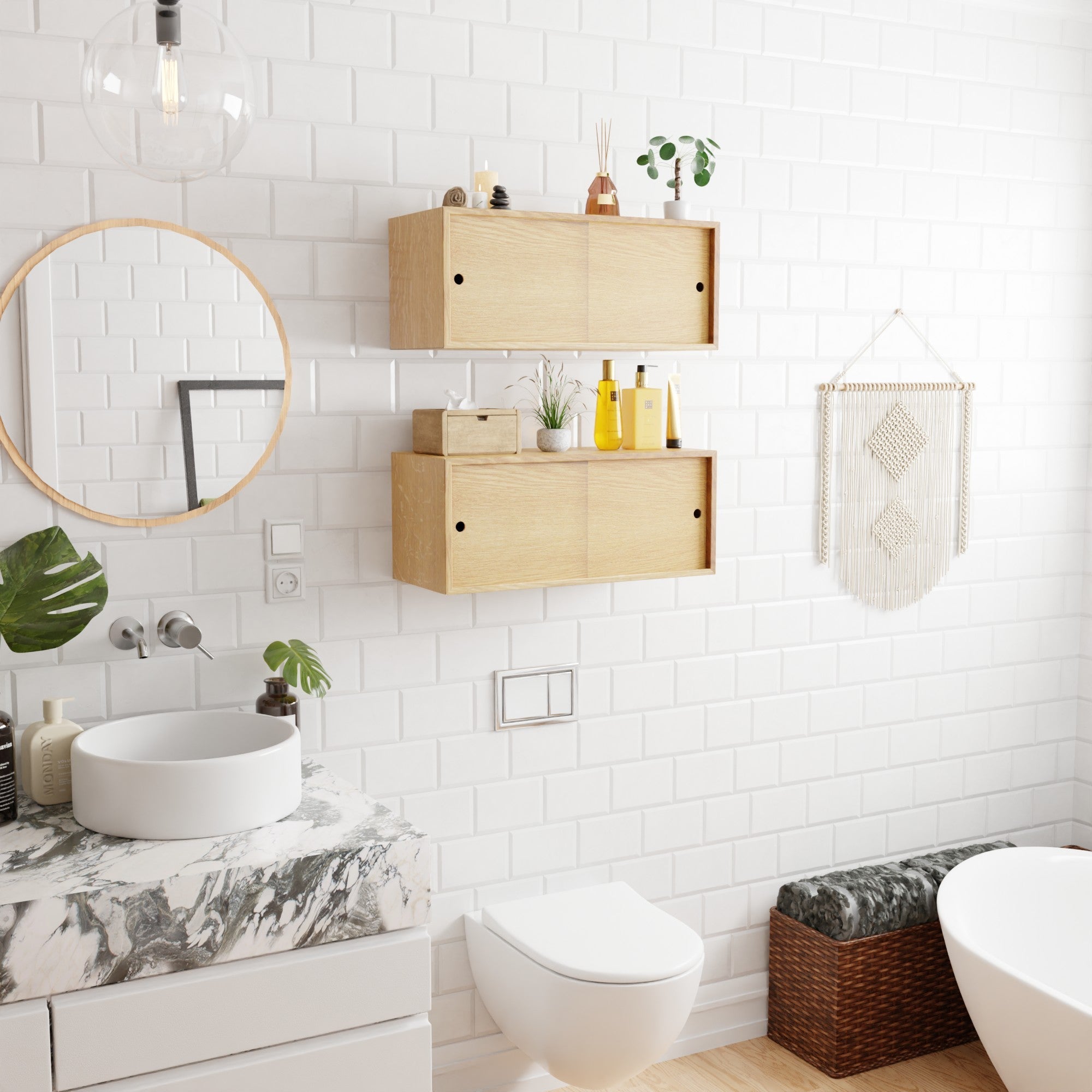 A modern bathroom with white subway tiles, a round mirror, a marble countertop with a round sink, wooden shelves, plants, a woven wall hanging, and a wicker storage bench.