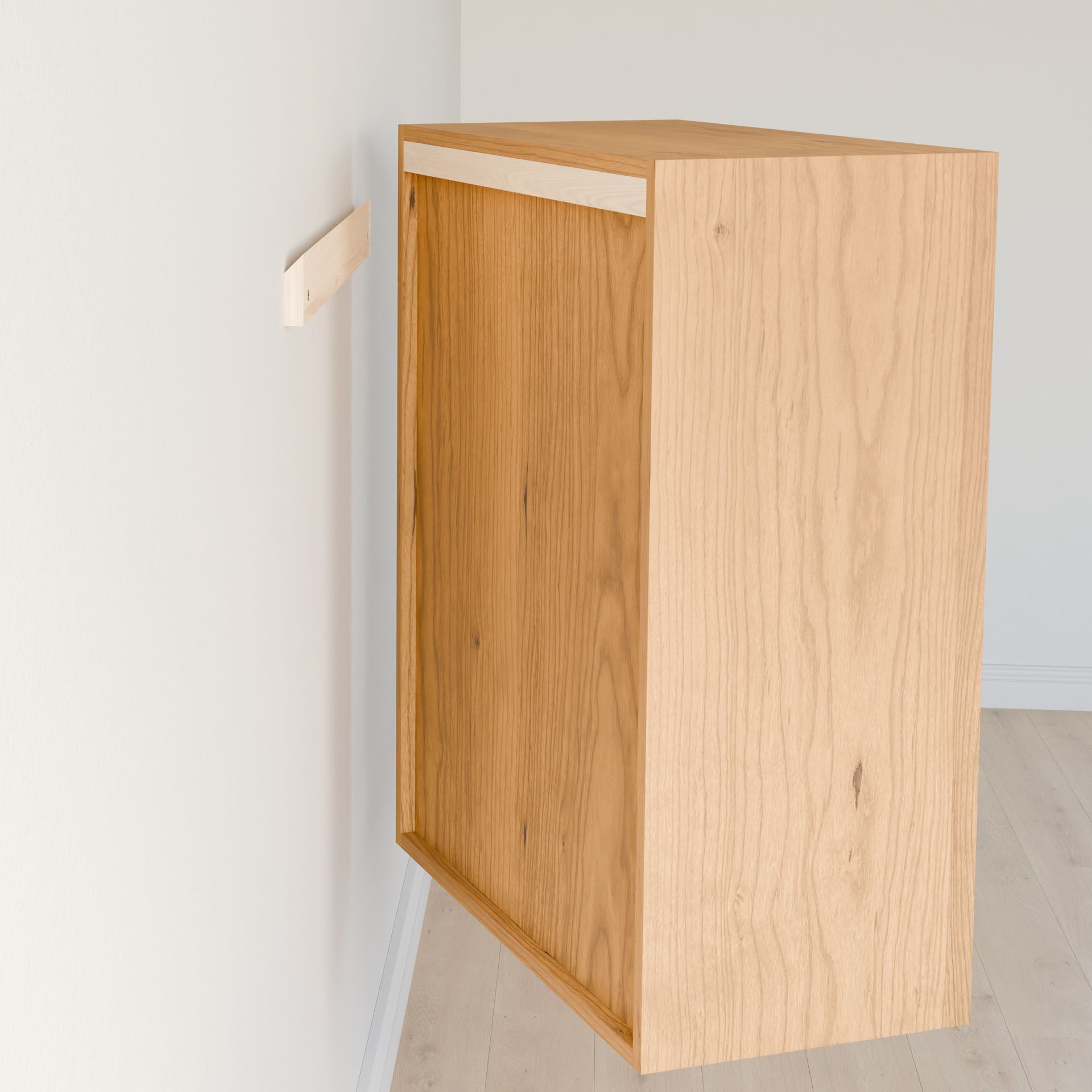 The Krovel Furniture Co. Closet Drawers and Shelves in Cherry is being mounted to a white wall using a French cleat; one half attached to the cabinet, the other half fixed to the wall, positioning it perfectly for installation. #configuration_triple-shelf