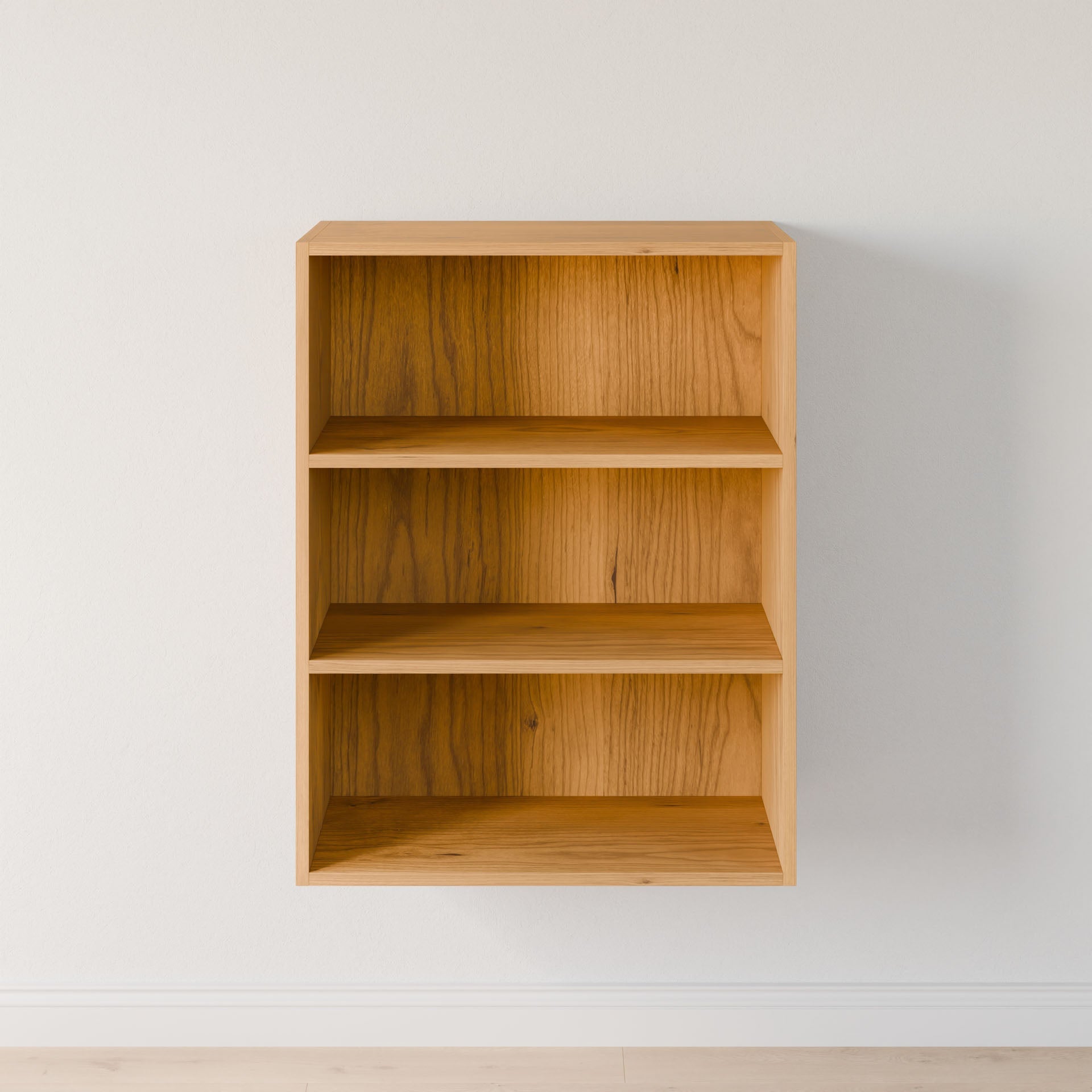 The Closet Drawers and Shelves in Cherry by Krovel Furniture Co., a compact wooden wall-mounted bookshelf with three shelves, stands against a white wall. Its minimalist, modular-like design casts a subtle shadow on the matching floor, with empty shelves ready for personalized décor. #configuration_triple-shelf