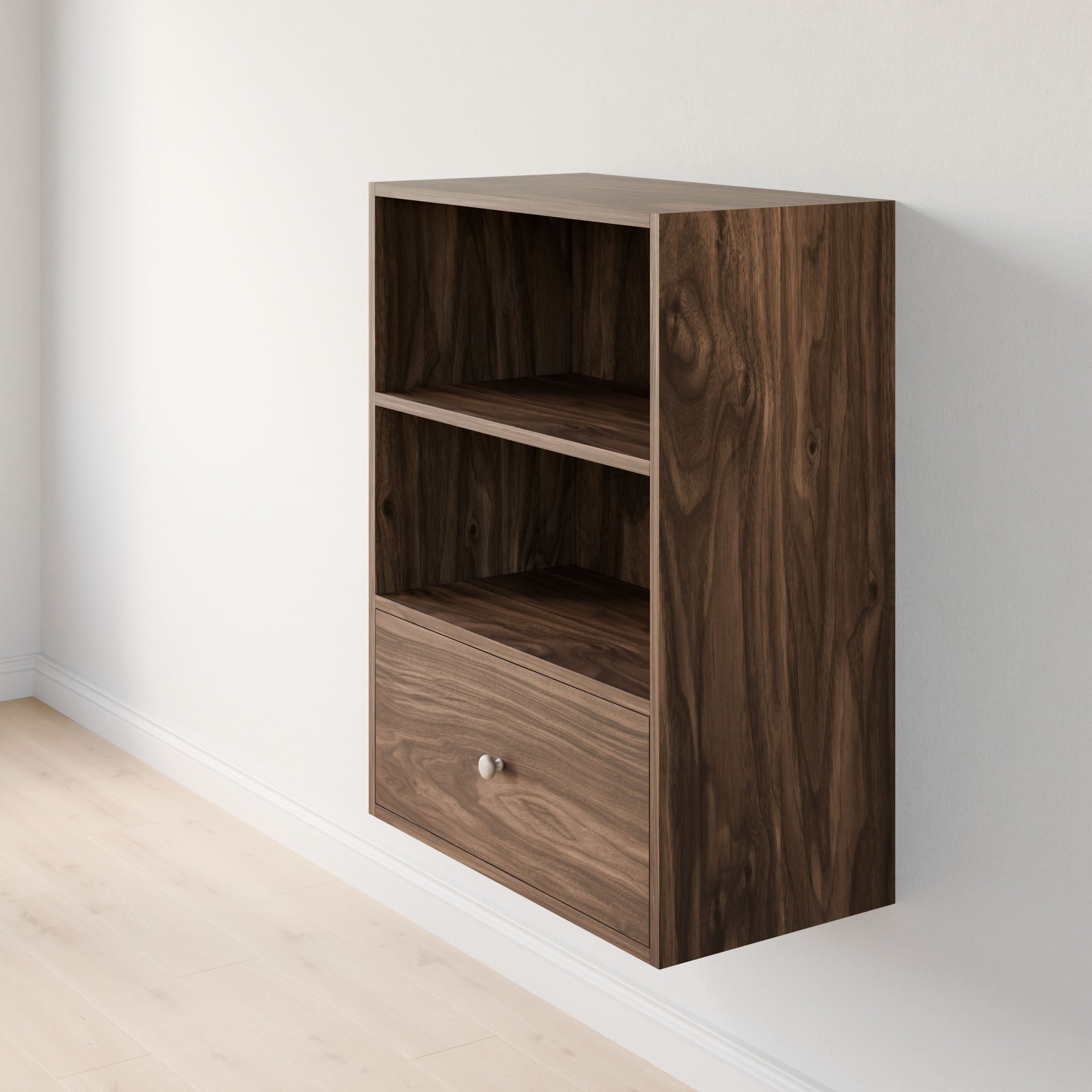 The Closet Drawers and Shelves in Walnut by Krovel Furniture Co. is a wall-mounted wooden shelf featuring dovetail construction, two open compartments, and one bottom drawer. Positioned against a light-colored wall on a wooden floor, it highlights a dark, natural grain pattern. 