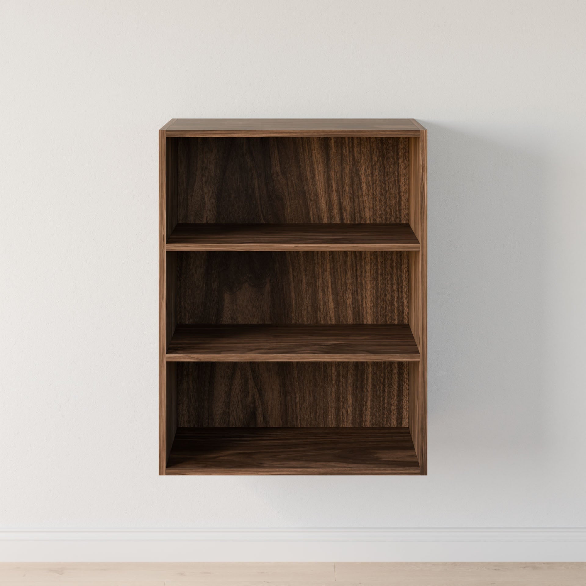 The Closet Drawers and Shelves in Walnut by Krovel Furniture Co. is a wall-mounted piece with three empty shelves, showcasing a dark wood finish and dovetail construction, featuring clean and simple lines against a plain white wall. #configuration_triple-shelf