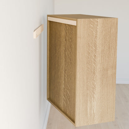 The Closet Drawers and Shelves in White Oak by Krovel Furniture Co. gives the impression of floating beside a white wall, held up by a discreet bracket. Made from premium plywood with a light wood finish, it seamlessly integrates with the light floor and wall without visible hardware. 