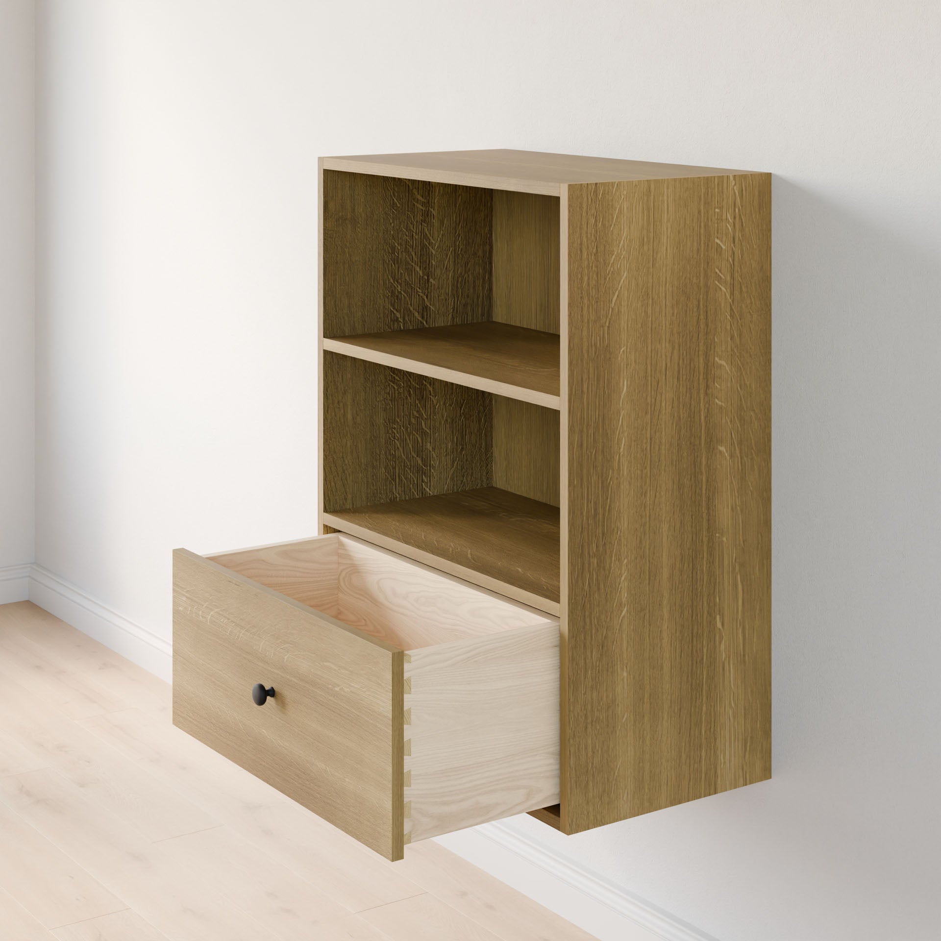 The Closet Drawers and Shelves in White Oak by Krovel Furniture Co. is a small wooden wall-mounted cabinet made from premium plywood, featuring two open shelves and an extended drawer with a black knob, set against a light wood floor. 