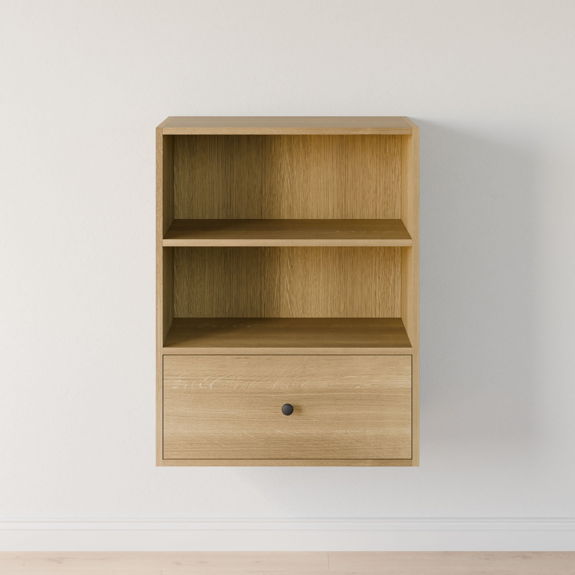 Krovel Furniture Co.'s Closet Drawers and Shelves in White Oak is a minimalist wall-mounted shelf crafted from premium-grade plywood. It features two open compartments, a drawer with a round black knob, and elegantly accents a plain white wall. 