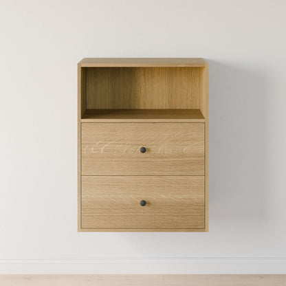 The Krovel Furniture Co.'s Closet Drawers and Shelves in White Oak is a compact, lightweight cabinet made from premium-grade plywood with an open top shelf and two drawers with black knobs, perfect for a plain white wall. 