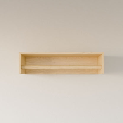 The Closet Hanger in Maple by Krovel Furniture Co. is a minimalist, handmade wooden rectangular shelf from Portland, Maine. Made with premium-grade plywood, it features a simple design with one horizontal support bar and a light natural wood finish to hang on your plain wall.