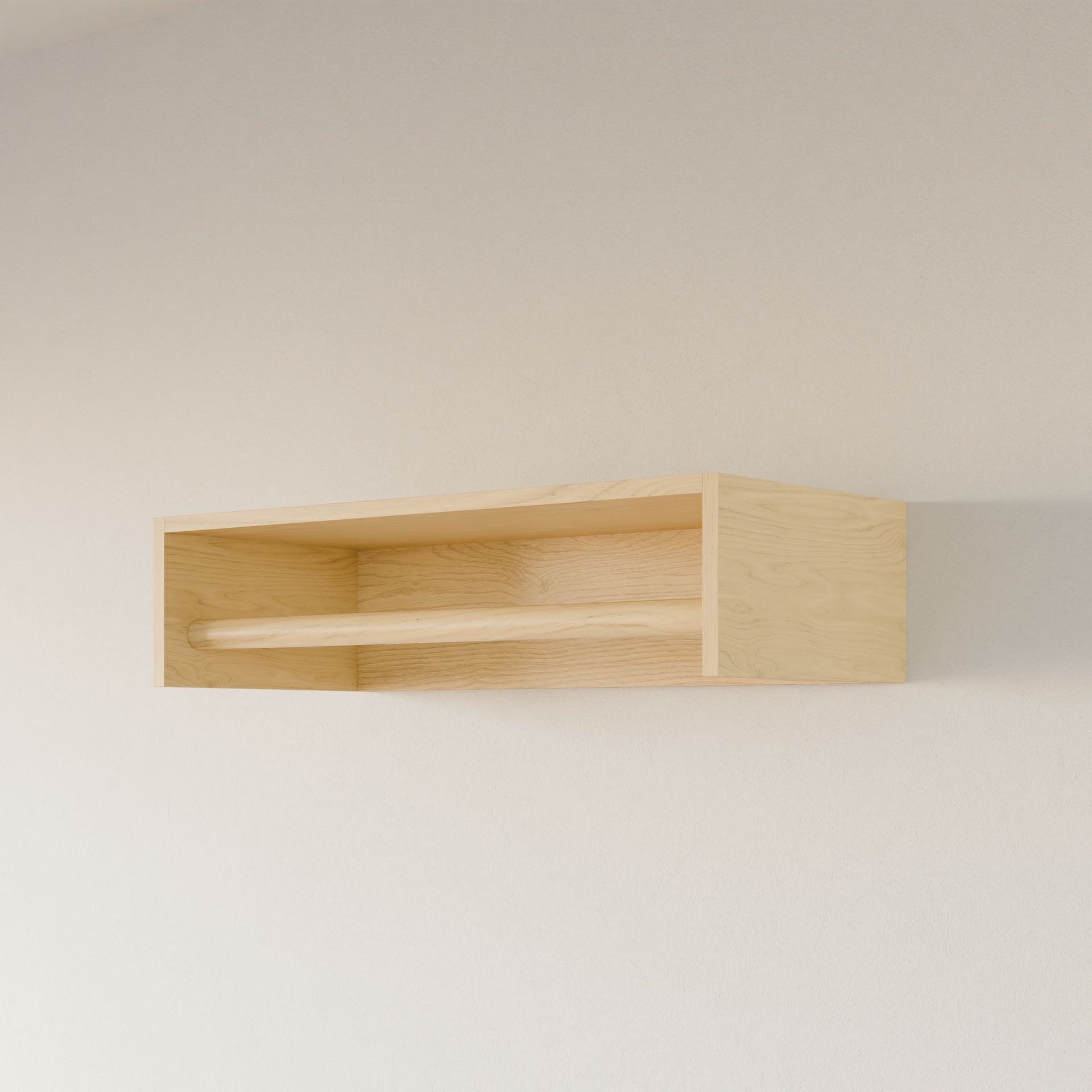 The Closet Hanger in Maple by Krovel Furniture Co. is a handmade, light-colored plywood wall shelf from Portland, Maine. It features a minimalistic design with a smooth finish and a horizontal wooden bar across the front for combined style and function, beautifully mounted on a pale wall.