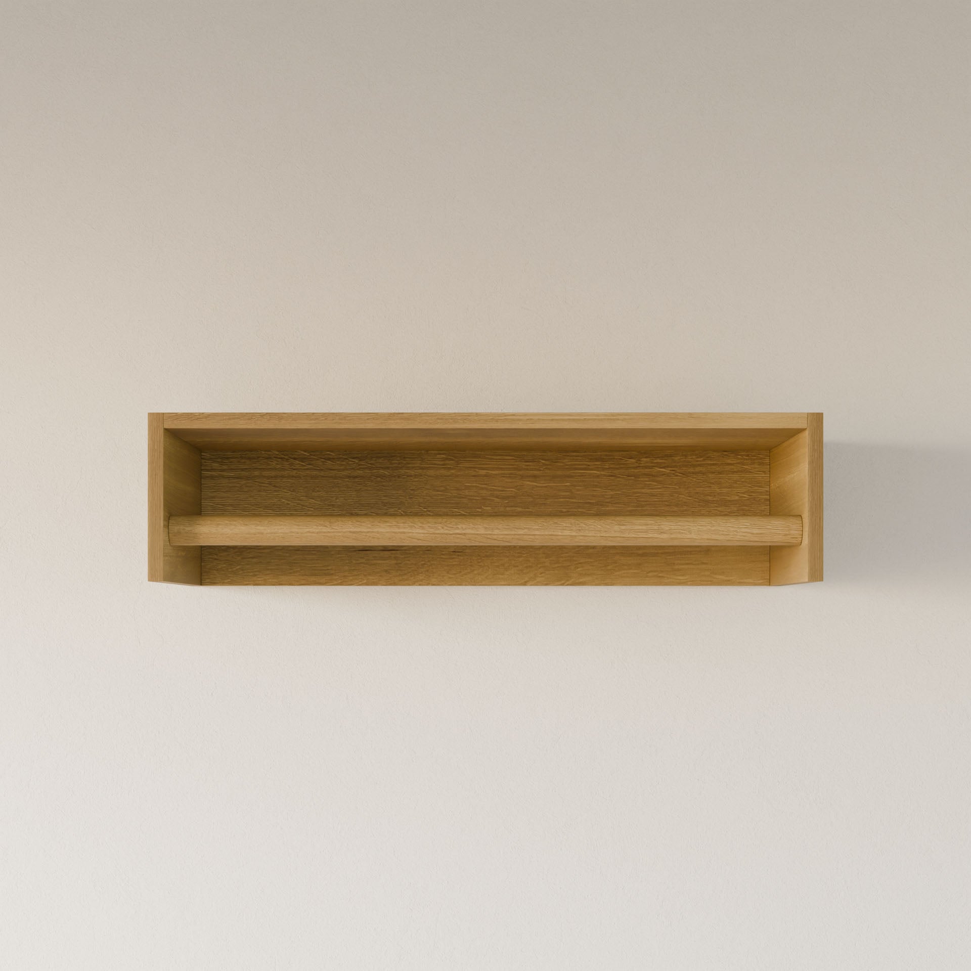 The Closet Hanger in White Oak by Krovel Furniture Co. is a handcrafted, rectangular wooden wall shelf made from premium cabinet plywood in Portland, Maine, featuring a front support bar and elegantly mounted on a light wall.