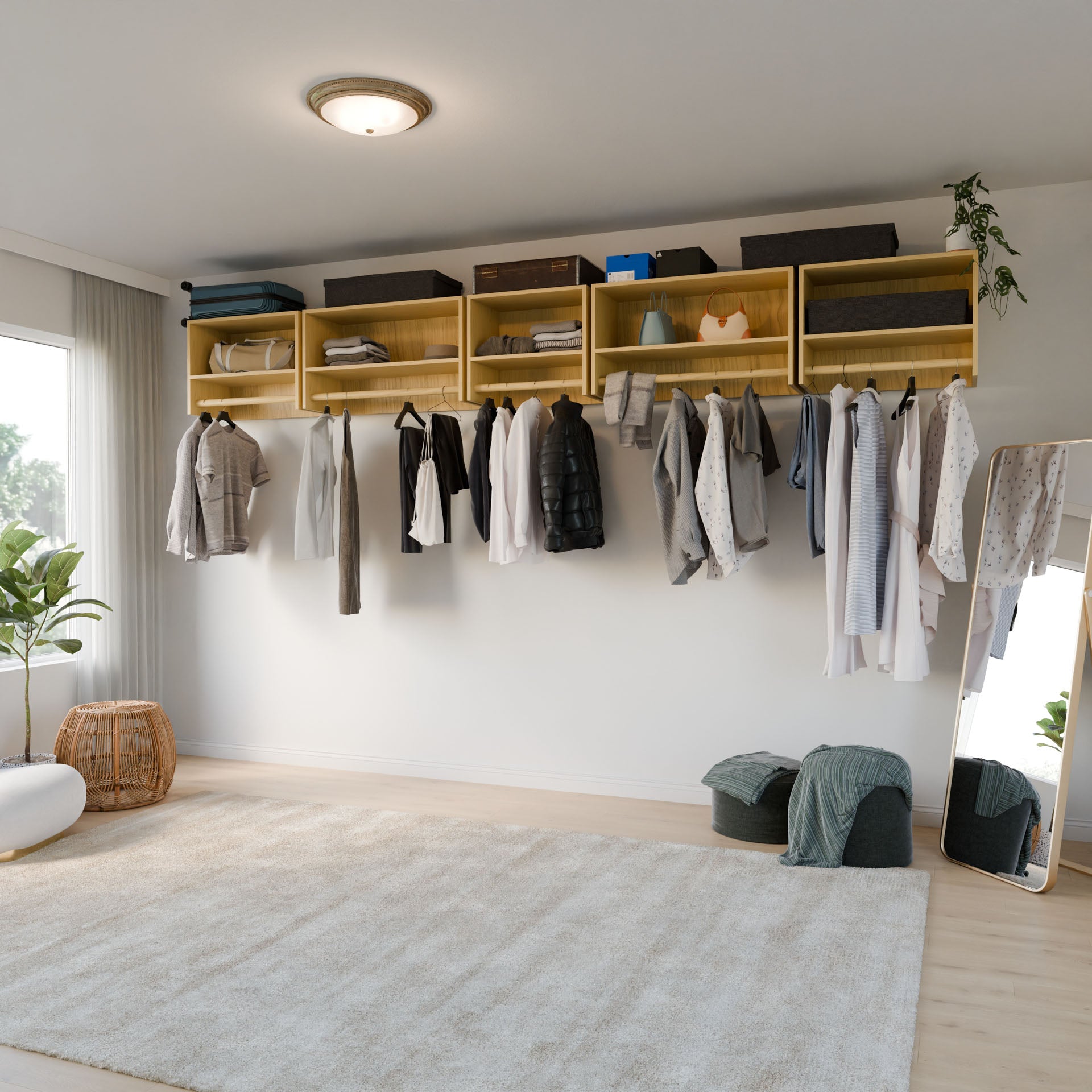 A minimalist room features Krovel Furniture Co.'s wall-mounted, modular "Closet Hanger with Shelf in Maple," crafted from premium grade cabinet plywood. Clothes hang elegantly, storage boxes sit above, and the space is enhanced by a full-length mirror, poufs, a plant, and a basket atop the soft rug on the wooden floor.