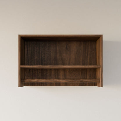 The Closet Hanger with Shelf in Walnut by Krovel Furniture Co. is a simple, handmade wooden shelf crafted in Portland, Maine. Featuring a premium-grade plywood finish and one horizontal divider, it showcases a natural dark grain pattern for an elegant touch against a plain light-colored wall.