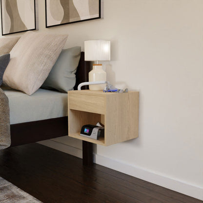 A minimalist bedroom features the Krovel CPAP Nightstand in Maple, offering a floating design that adds a mid-century modern touch. A white lamp and a CPAP hose with mask rest on the top, and a device finds its place on the lower shelf. Abstract art above the bed enhances the tranquil ambiance.