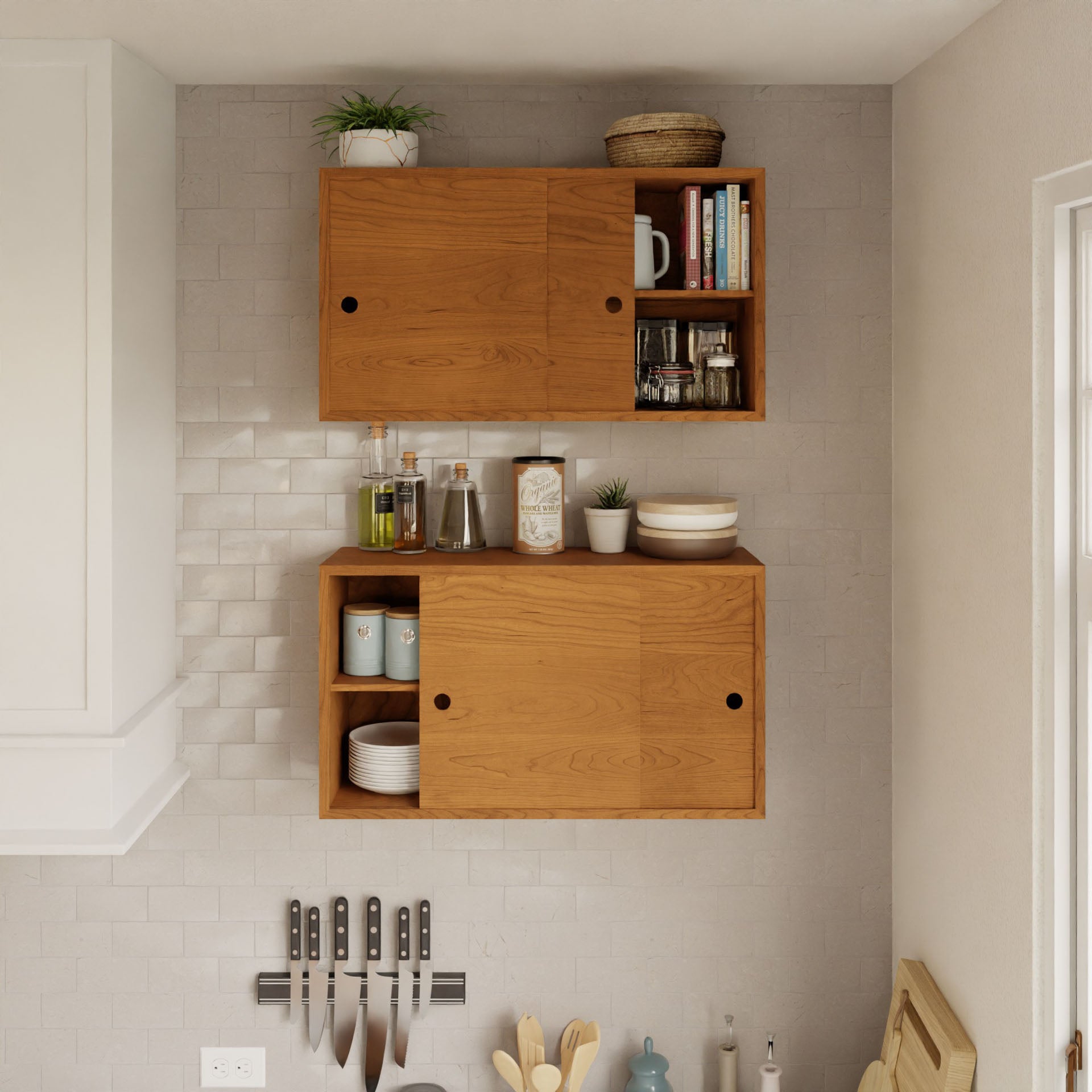 A kitchen wall showcases the Krovel "Cupboard with Shelf in Cherry," featuring floating storage cabinets perfect for displaying plants, dishes, and spices. A magnetic strip beneath the cabinets holds six knives. In the corner, a cutting board and utensils are visible. The light gray tiled wall enhances the overall elegance of the space.