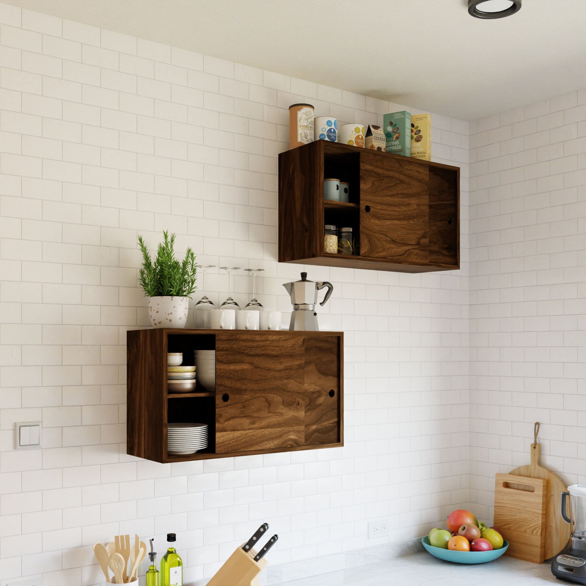 A modern kitchen with white subway tiles showcases the Krovel Cupboard with Shelf in Walnut displaying mugs and jars, while hand-finished floating storage cabinets hold cereal boxes. A potted plant, glasses, and a stovetop espresso maker add charm to the lower cabinet.