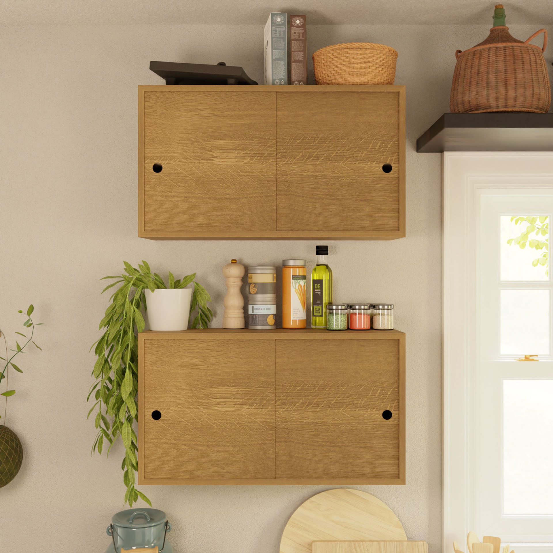 Krovel's Cupboard with Shelf in White Oak is mounted on a wall, featuring closed doors. Items such as books, a basket, and a black bottle are placed on top. Below, various kitchen supplies, spices, and a plant are neatly organized. Sunlight streams through a nearby window, casting shadows on the floating storage cupboard.