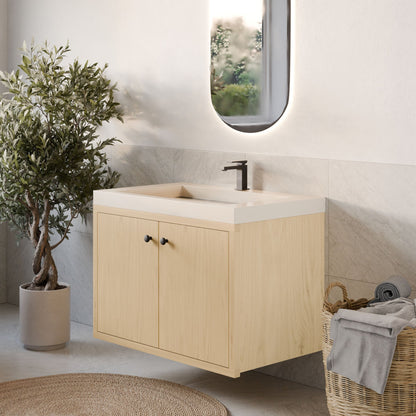 A modern bathroom showcases Krovel Furniture Co.'s Double Door Vanity in Maple with soft-close hinges and a sleek faucet beneath an oval backlit mirror. Nearby, a potted plant complements the light-colored tile floor, while a wicker basket holds towels.