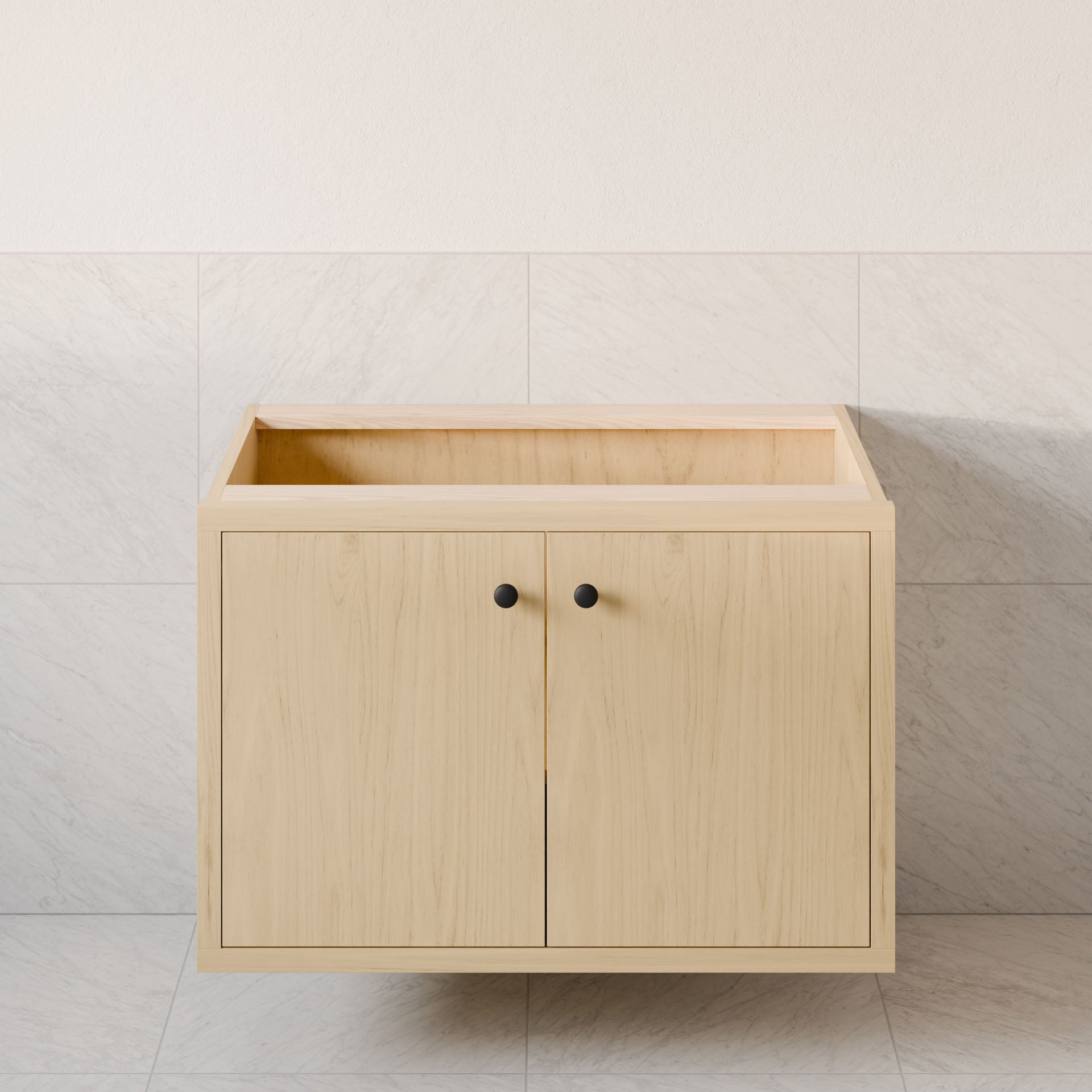 A Krovel Furniture Co. Double Door Vanity in Maple, featuring hardwood veneer, black knobs, and soft-close hinges, is set against light gray tiled walls and floor. It appears to be designed as a floating vanity for bathroom or kitchen use.