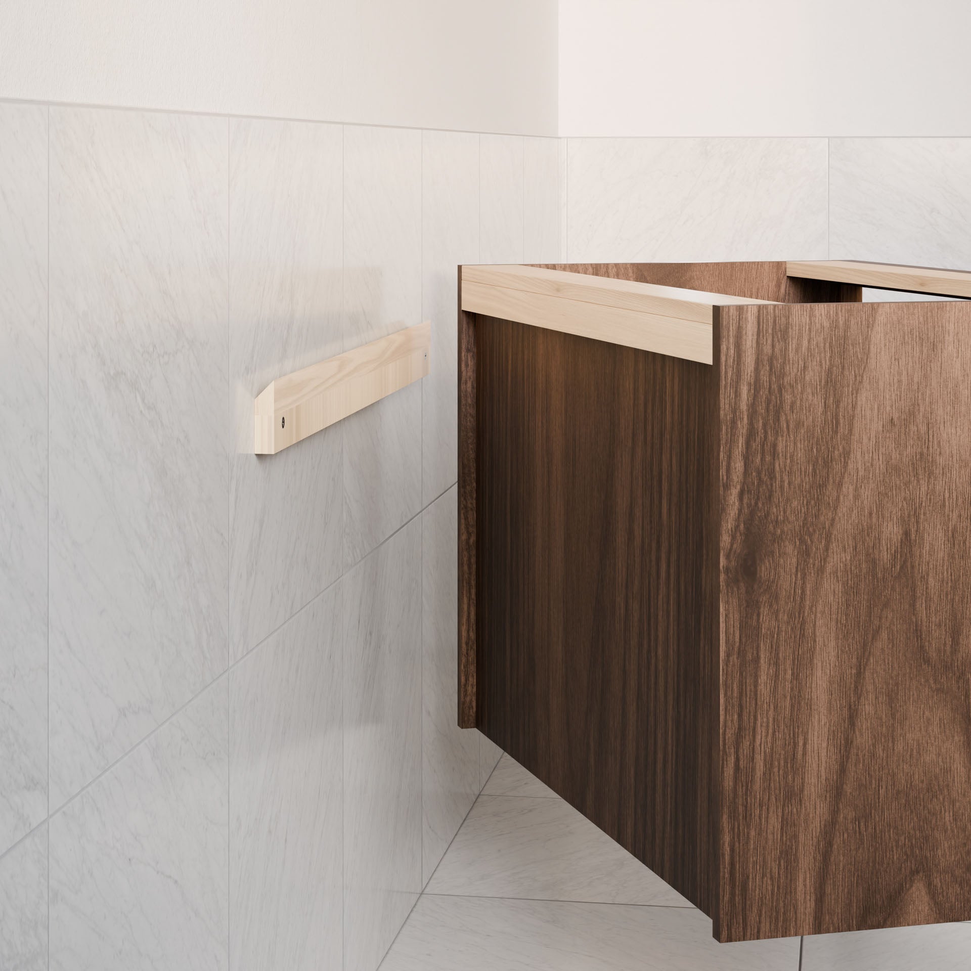 A wooden floating shelf with a hardwood veneer finish is on a light gray tiled wall beside a partially visible Double Door Vanity in Walnut by Krovel Furniture Co., set against a simple, neutral wall backdrop.