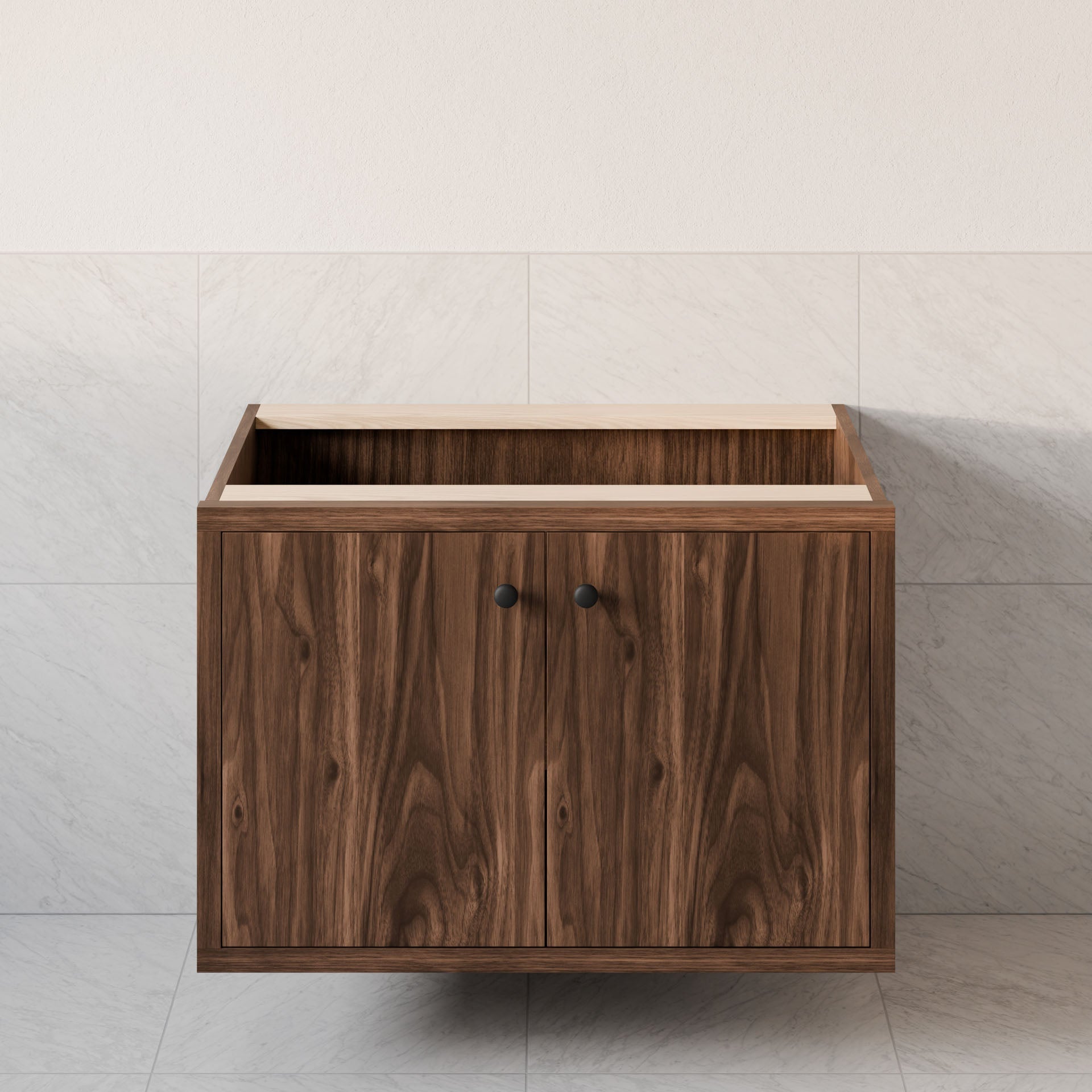 The Double Door Vanity in Walnut by Krovel Furniture Co. features hardwood veneer and dark handles against a light tiled wall, showcasing natural wood grain. It has an open top space and modern soft-close hinges.