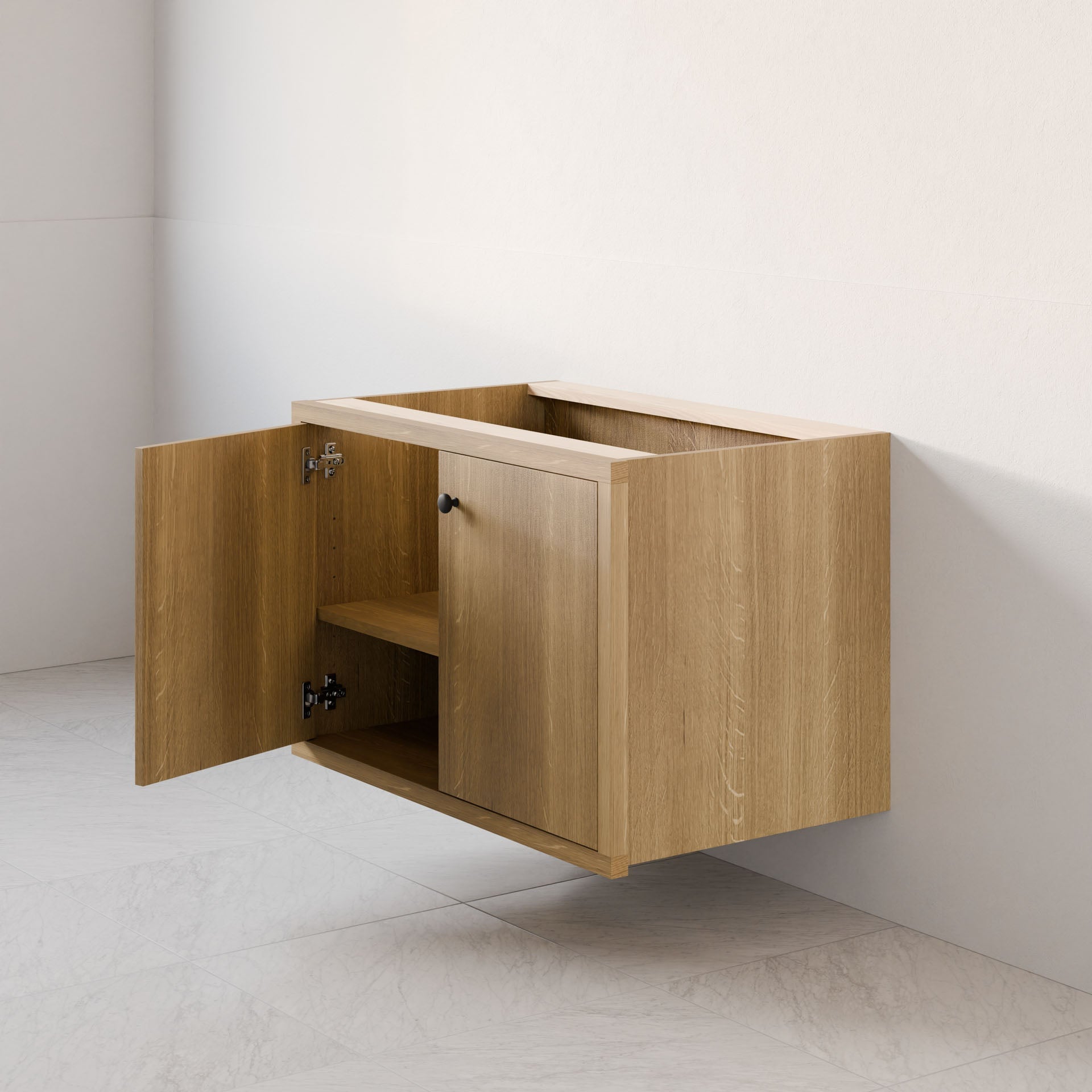 The Double Door Vanity in White Oak by Krovel Furniture Co. is a minimalist hardwood veneer cabinet with a light finish, featuring soft-close hinges on its two open doors. It has a single shelf inside and is positioned as a floating vanity above a tiled floor against a white wall.