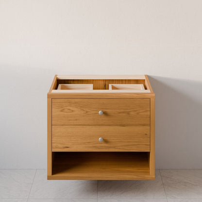 The Double Drawer, Open Shelf Vanity in Cherry by Krovel Furniture Co. is a floating wooden bathroom piece featuring dovetail joinery, two drawers with modern silver knobs, and top cutouts for sinks. It rests beautifully against a neutral wall on a tiled floor.