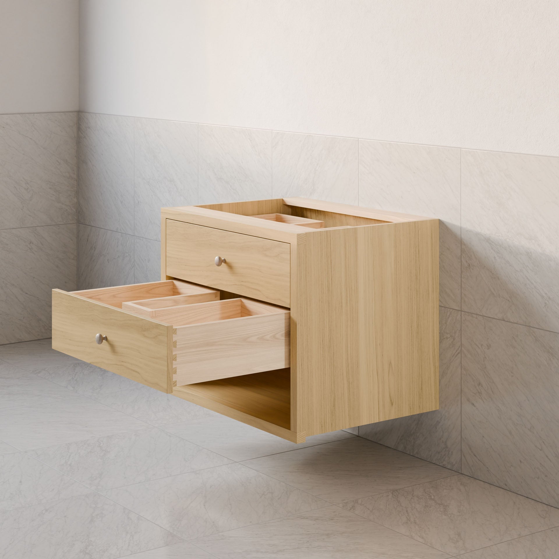 The Double Drawer, Open Shelf Vanity in Maple by Krovel Furniture Co. features open drawers and complements light-colored marble tiles. With a sleek, modern design and hardwood veneer, it fits seamlessly into any kitchen or bathroom. Custom sizes ensure a perfect fit for your space.