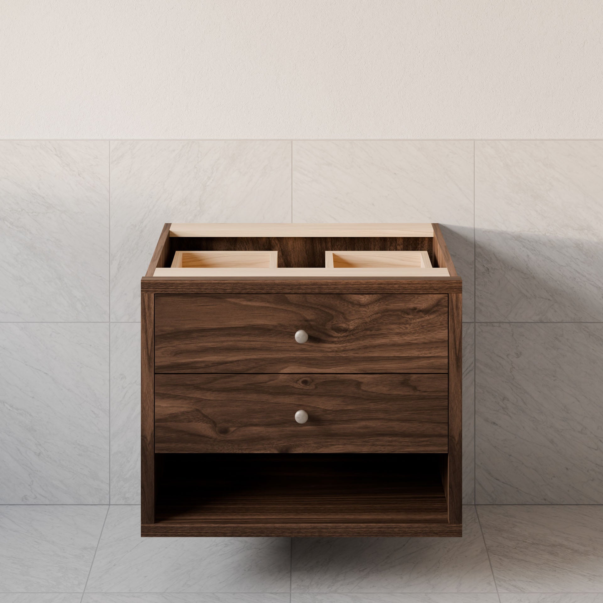 The Double Drawer, Open Shelf Vanity in Walnut by Krovel Furniture Co. is a custom-sized floating wooden bathroom vanity against a tiled wall, featuring two drawers with silver knobs and an open shelf at the bottom. Made from hardwood veneer, its countertop awaits sink fixtures.