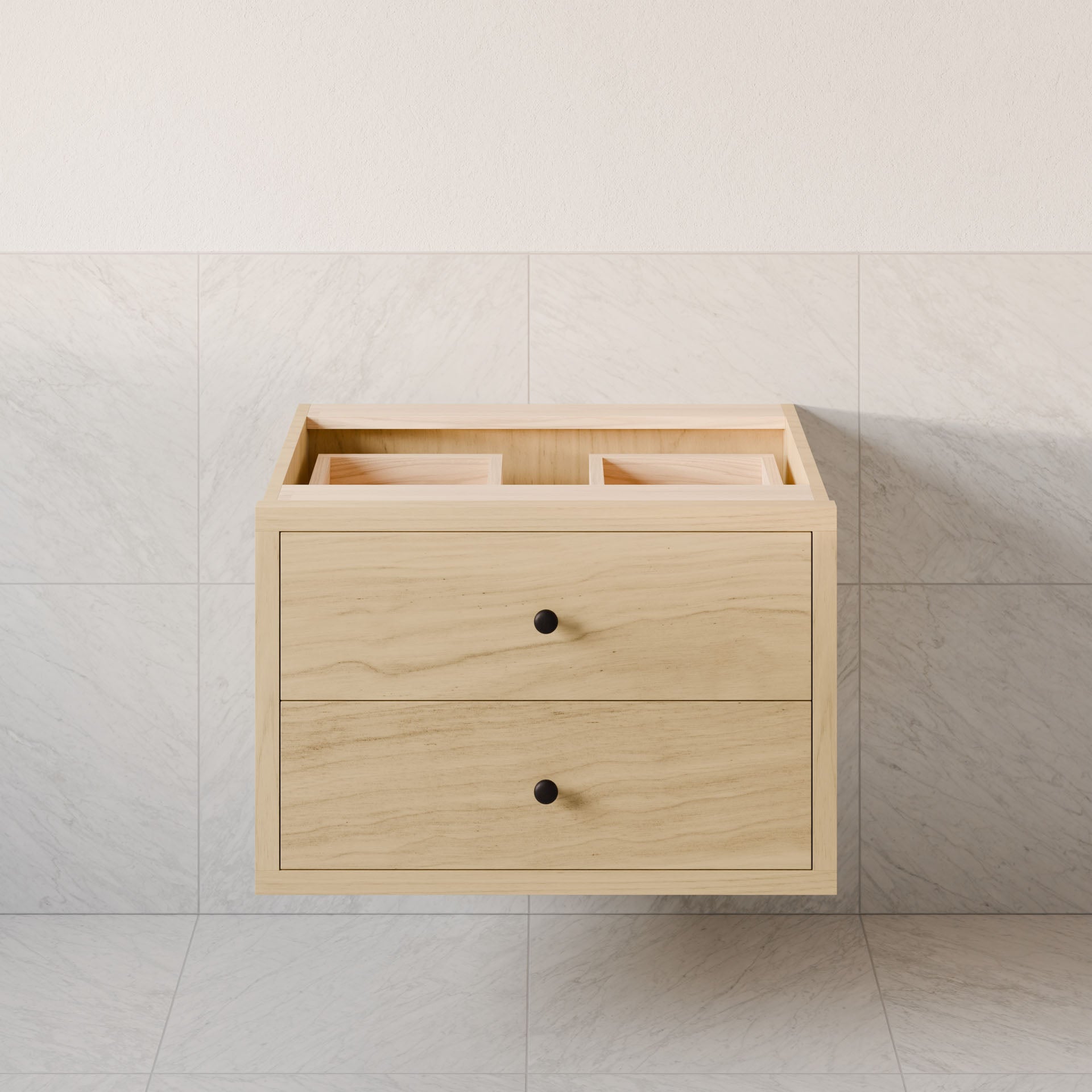 The Double Drawer Vanity in Maple by Krovel Furniture Co. features two drawers with black knobs, mounted on a light tiled wall. Made of hardwood veneer, the open top is prepared for a sink, revealing compartments inside and showcasing minimalist modern design elements.