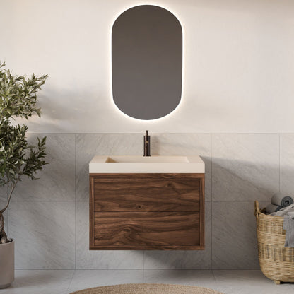 A modern bathroom features a Double Drawer Vanity in Walnut by Krovel Furniture Co., complemented by a rectangular sink and an oval backlit mirror. Gray tiles line the walls, while a woven basket with towels and a leafy green plant enhance charm. A round beige rug ties it all together.