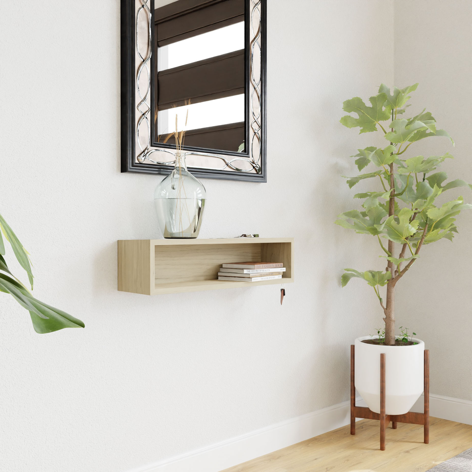 A modern interior features a Krovel Entryway Organizer in Maple holding books and a glass vase, mounted on a white wall below a decorative mirror. A tall potted plant on the right adds greenery to the minimalist setting.