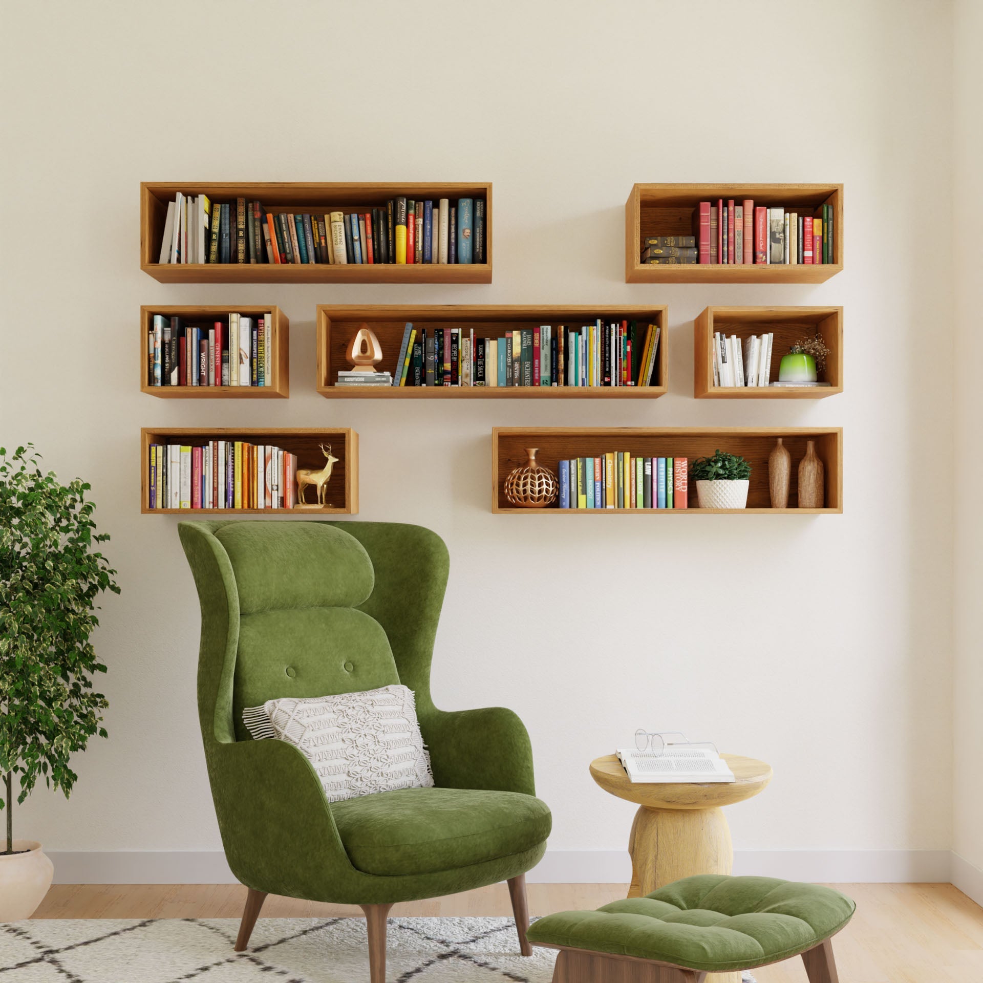 A cozy reading nook includes a green armchair, a small wooden table, and Krovel's Floating Bookshelf in Cherry, filled with books and decor. A potted plant is to the left, all set against a light-colored wall.