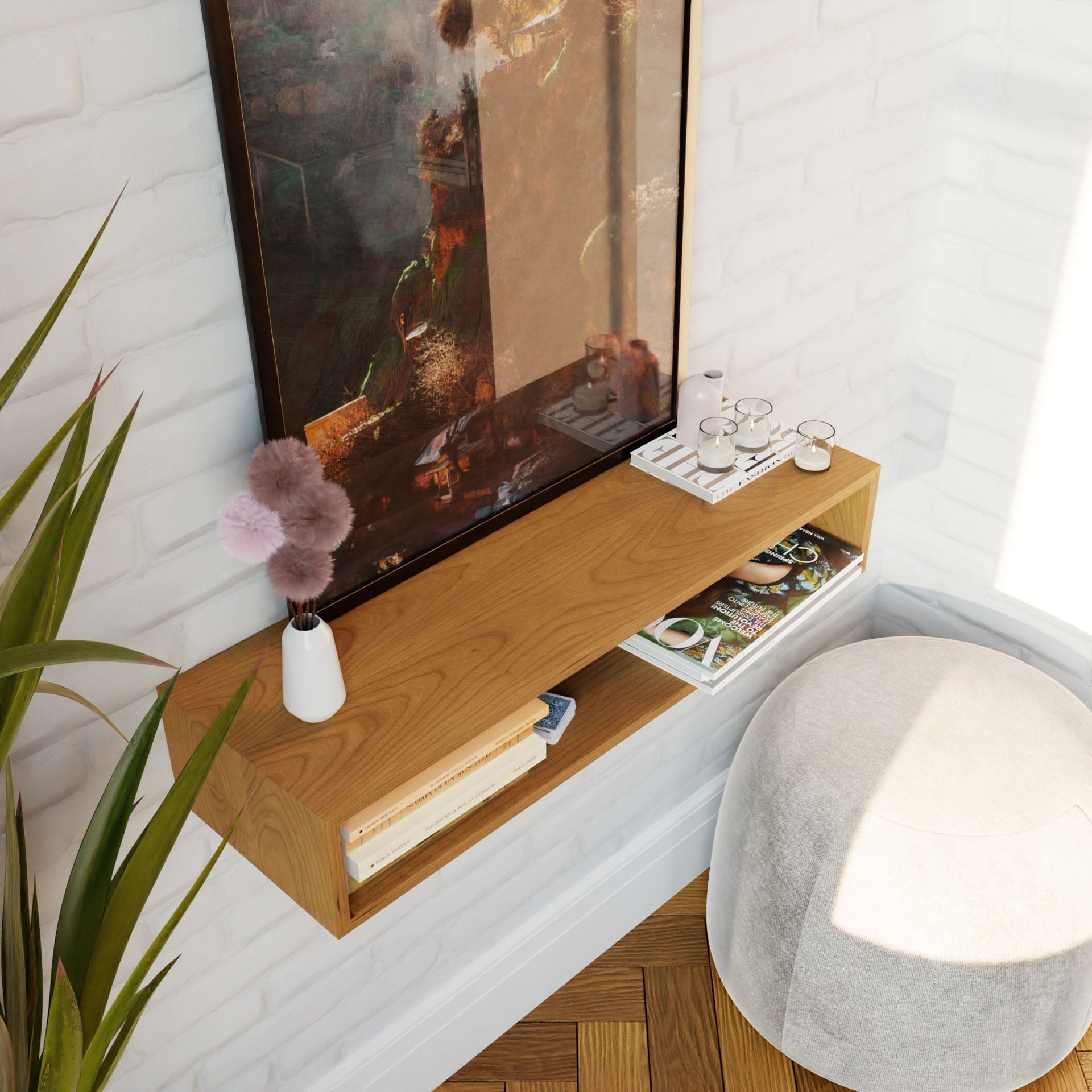 A cozy corner showcases a wooden shelf filled with books, magazines, and glasses. Atop the Krovel Floating Console Table in Cherry, a white vase displays a fluffy decorative item in perfect harmony with the mid-century modern aesthetic. A large framed painting is elegantly hung above. Nearby, a round cushioned stool sits on the American Cherry floor while a plant adds vibrant greenery to the scene.