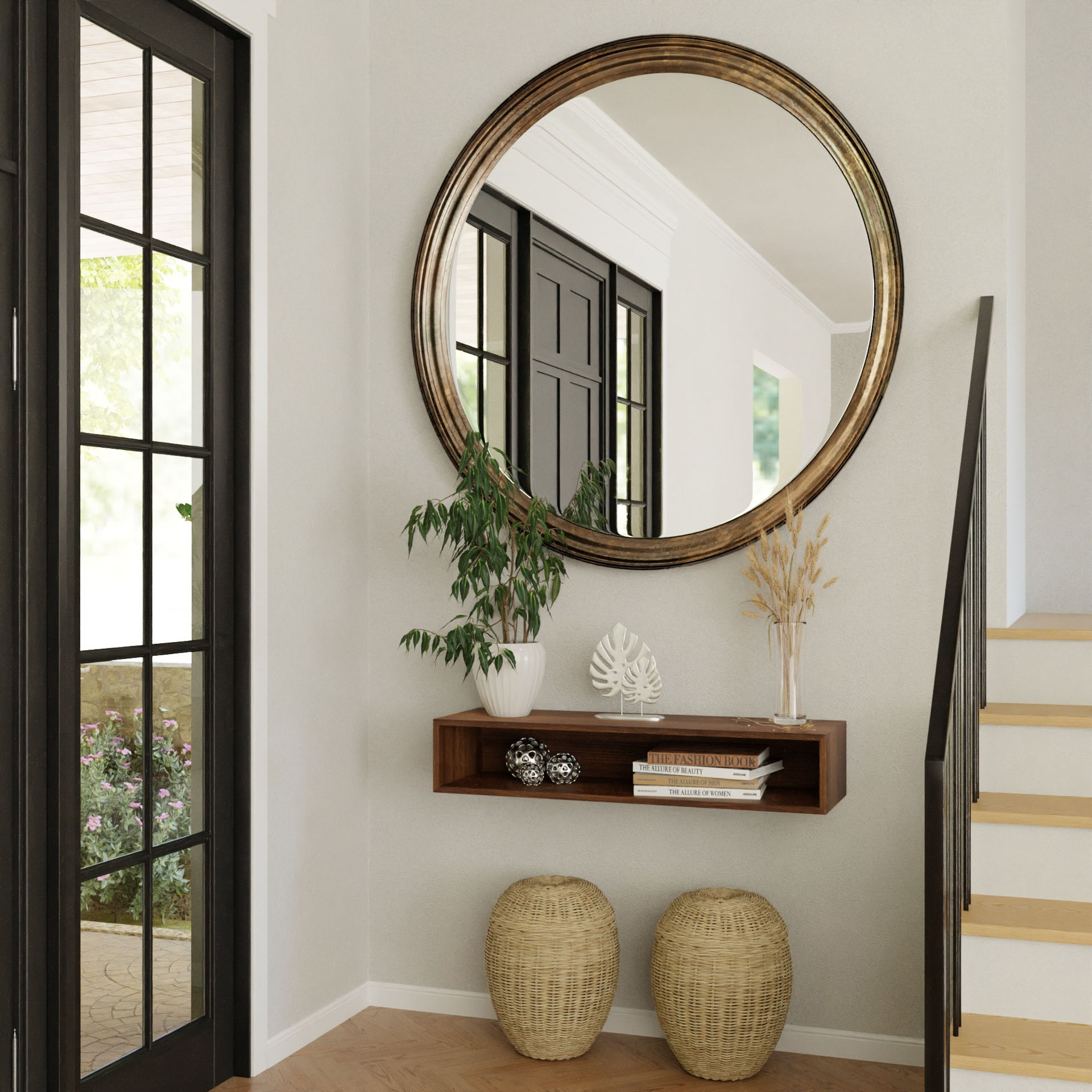 A modern hallway showcases a Krovel Floating Console Table in Walnut with a large round mirror above. The shelf displays a potted plant, decor, and a vase of dried grasses, while two woven baskets sit below. A staircase and glass-paneled door enhance the mid-century modern vibe.