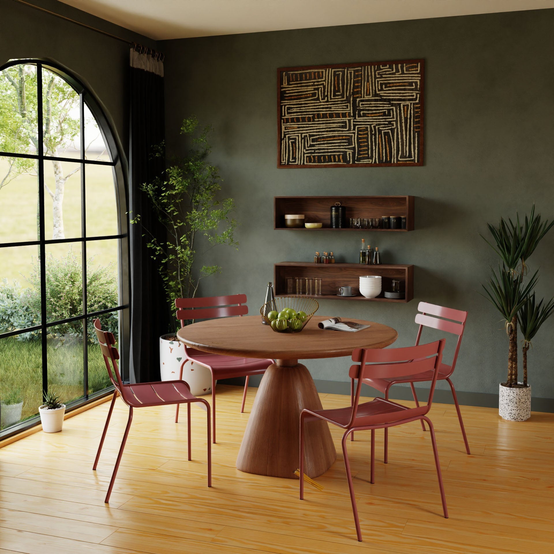 A modern dining room showcases a round Black Walnut table, complemented by four vibrant red chairs. A large window offers a view of the lush green garden outside. The walls are elegantly adorned with Krovel's Floating Display Cases in Walnut and patterned artwork, while handmade plants bring a natural touch to the space.