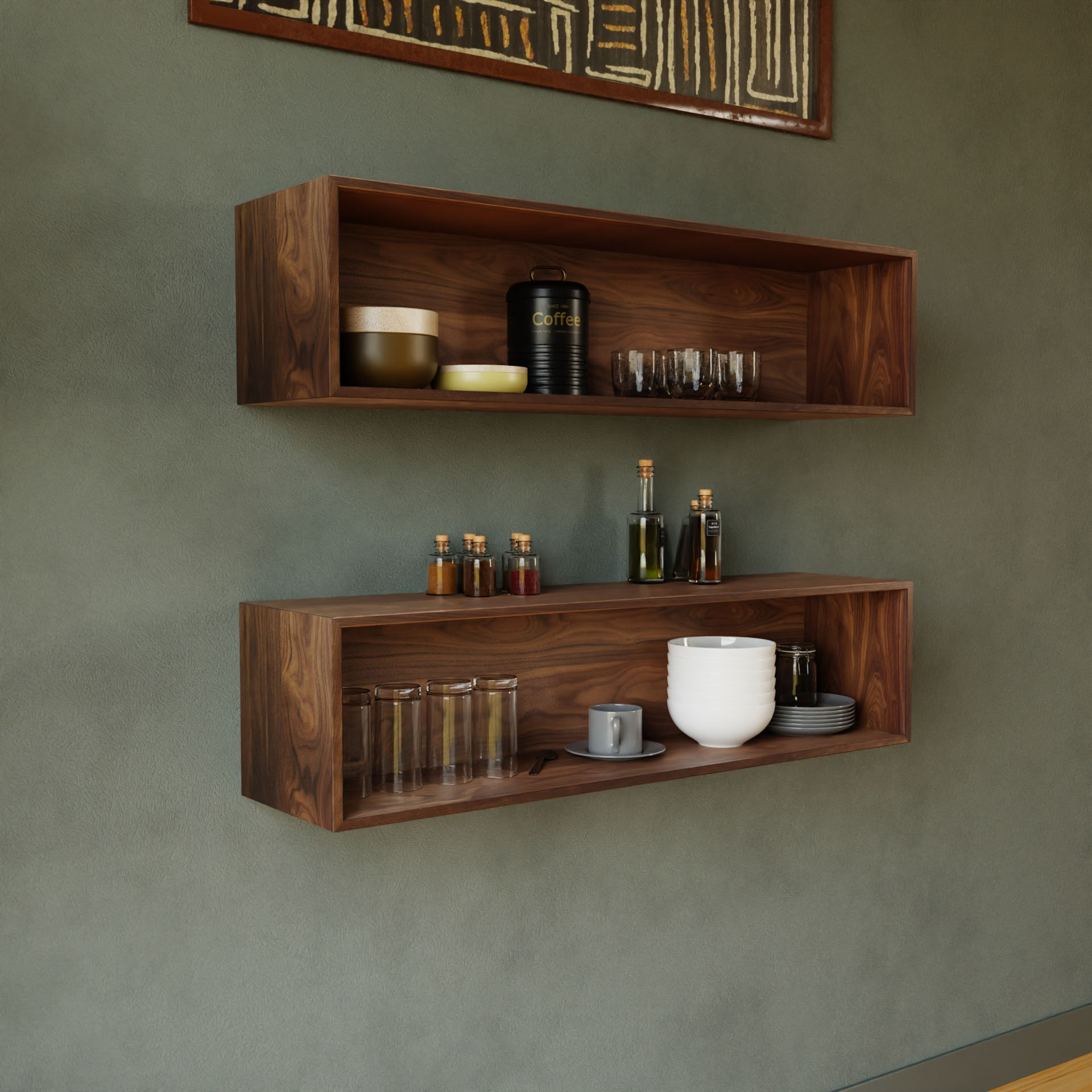 Two handmade floating display cases in walnut by Krovel hold various kitchen items, including jars, a coffee tin, glassware, bottles of oil, and bowls. Mounted on a green wall beneath abstract art, they create a stylish and minimalist kitchen decor.