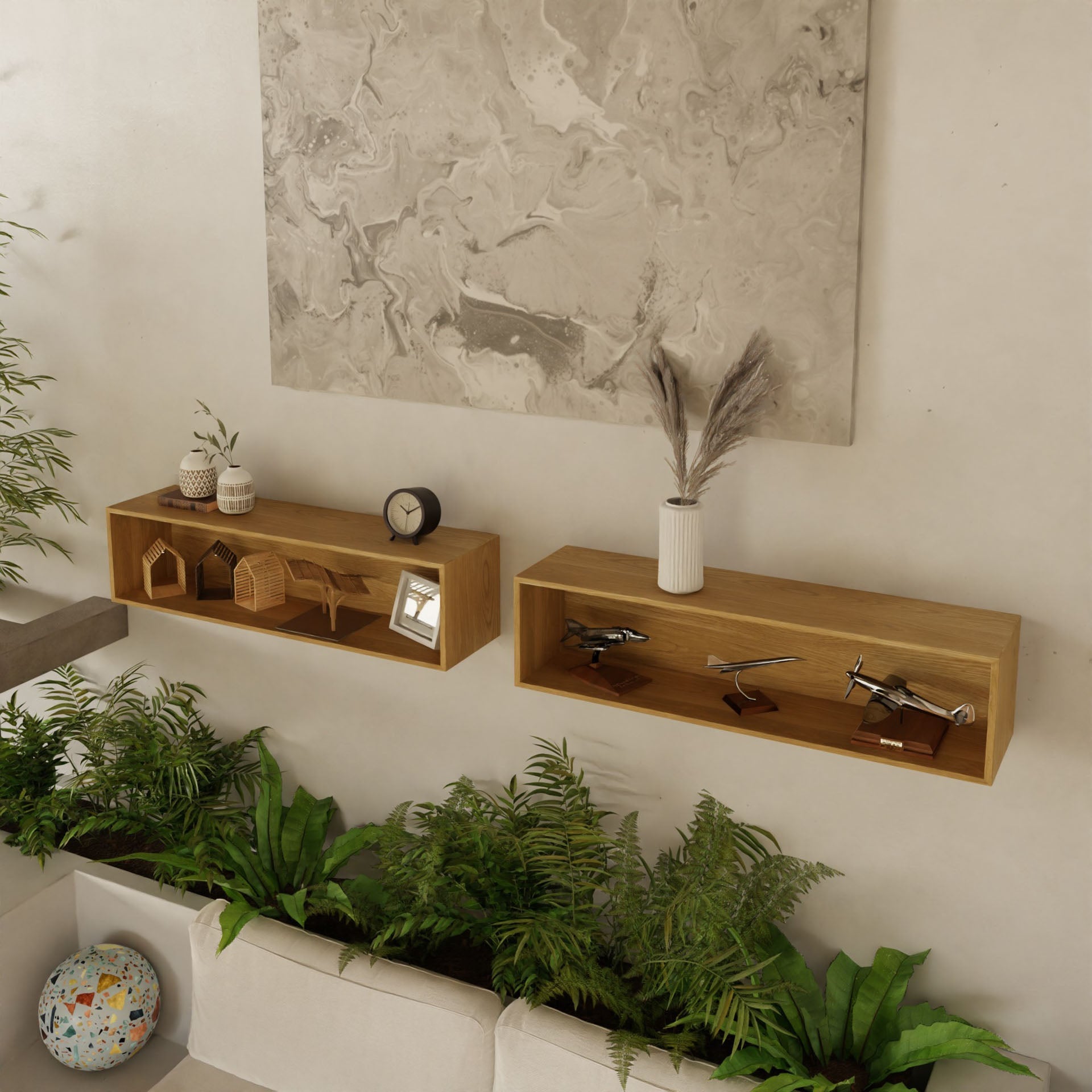 A modern living room showcases two Krovel Floating Display Cases in White Oak. These shelves hold small decorative items, such as wooden houses and model airplanes. Below, green plants adorn a white couch, while a large abstract artwork is mounted on the wall above the display cases.