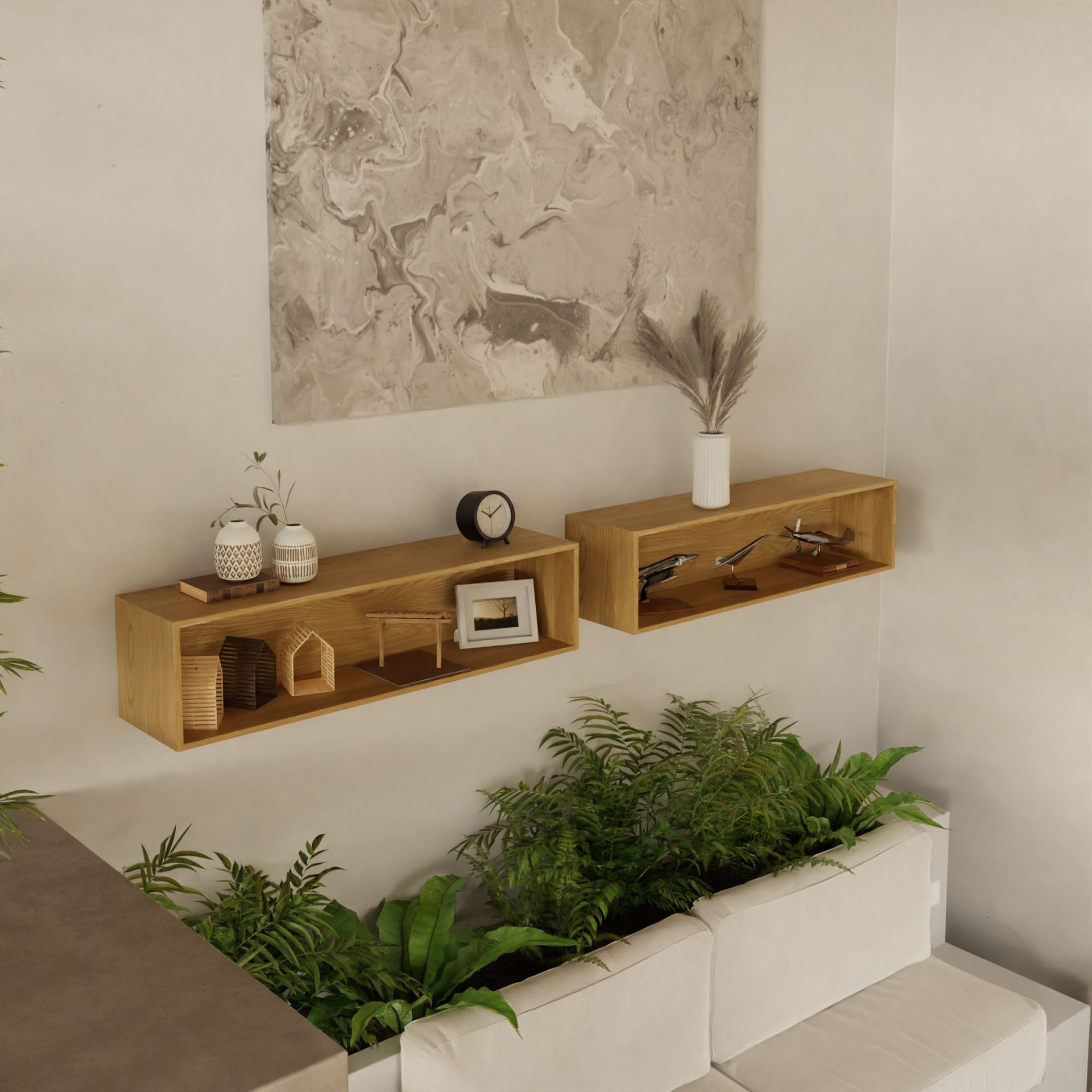 A minimalist room with light gray walls features two Krovel Floating Display Cases in White Oak showcasing decor and a clock. Green plants accent a white sofa, and an abstract painting is secured above using a French cleat system.