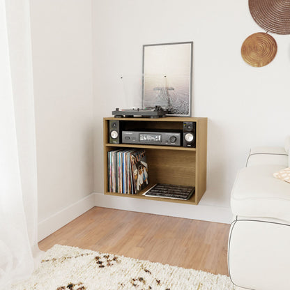 A cozy room corner is highlighted by a Krovel Record and Stereo Storage Cabinet in White Oak, showcasing a turntable, receiver, and speakers. Vinyl records are neatly stored below. A framed picture adorns the top. Nearby, a white sofa and cream rug further enhance the peaceful ambiance.