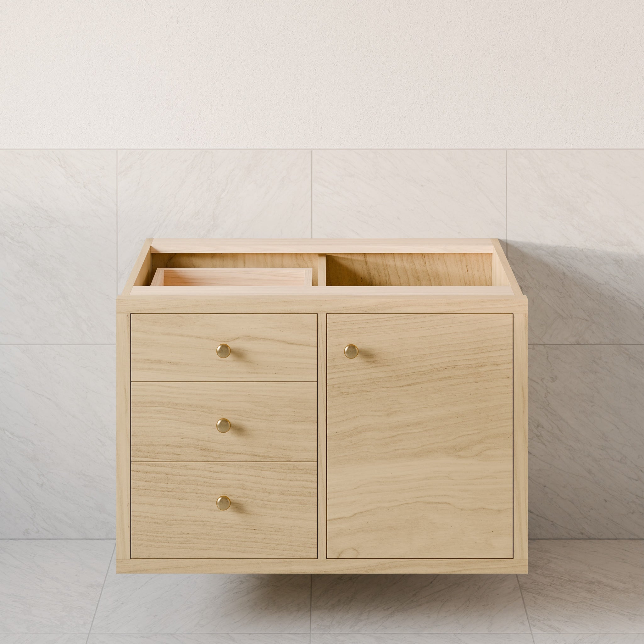 The Krovel Furniture Co. Single Door, Triple Drawer Vanity in Maple features a floating design with a light hardwood veneer finish against a tiled wall. It has two soft-close drawers with round knobs on the left and a door with a similar knob on the right, and an open top for sink installation.