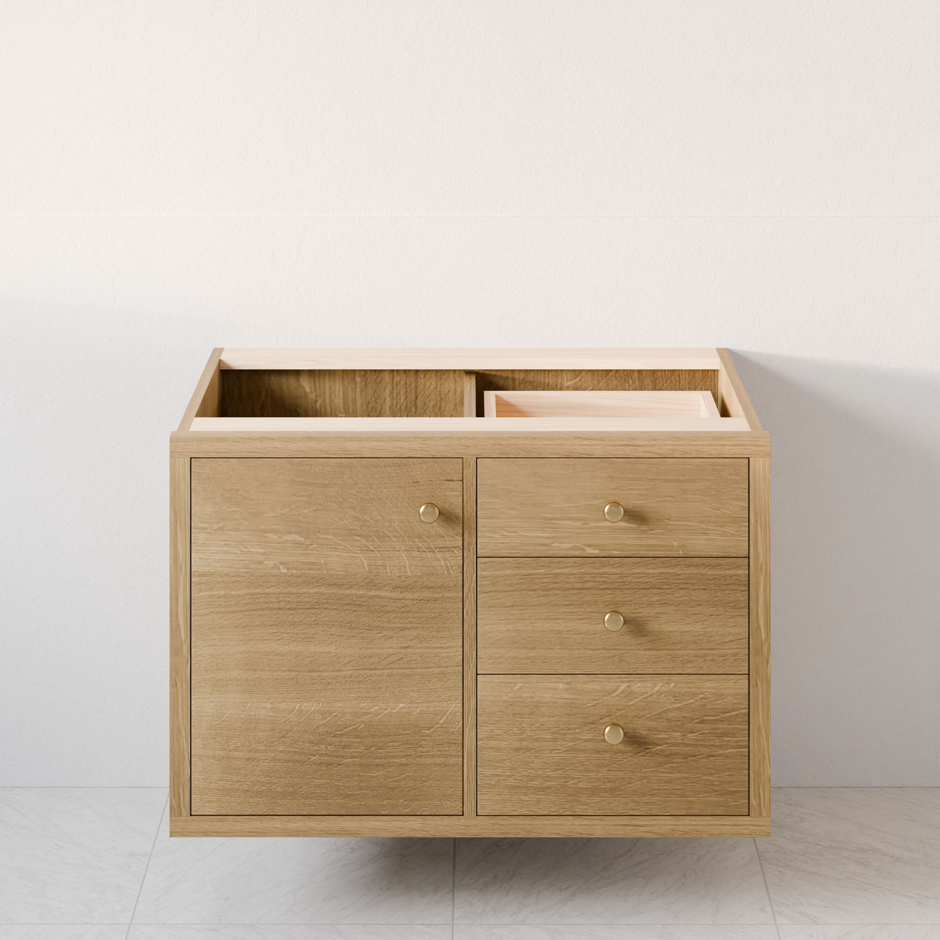 The Krovel Furniture Co. Single Door, Triple Drawer Vanity in White Oak features a hardwood veneer cabinet with three soft-close drawers on the right and a single door on the left, set against a plain light-colored wall. The open top reveals the interior, atop light-colored tiled flooring.