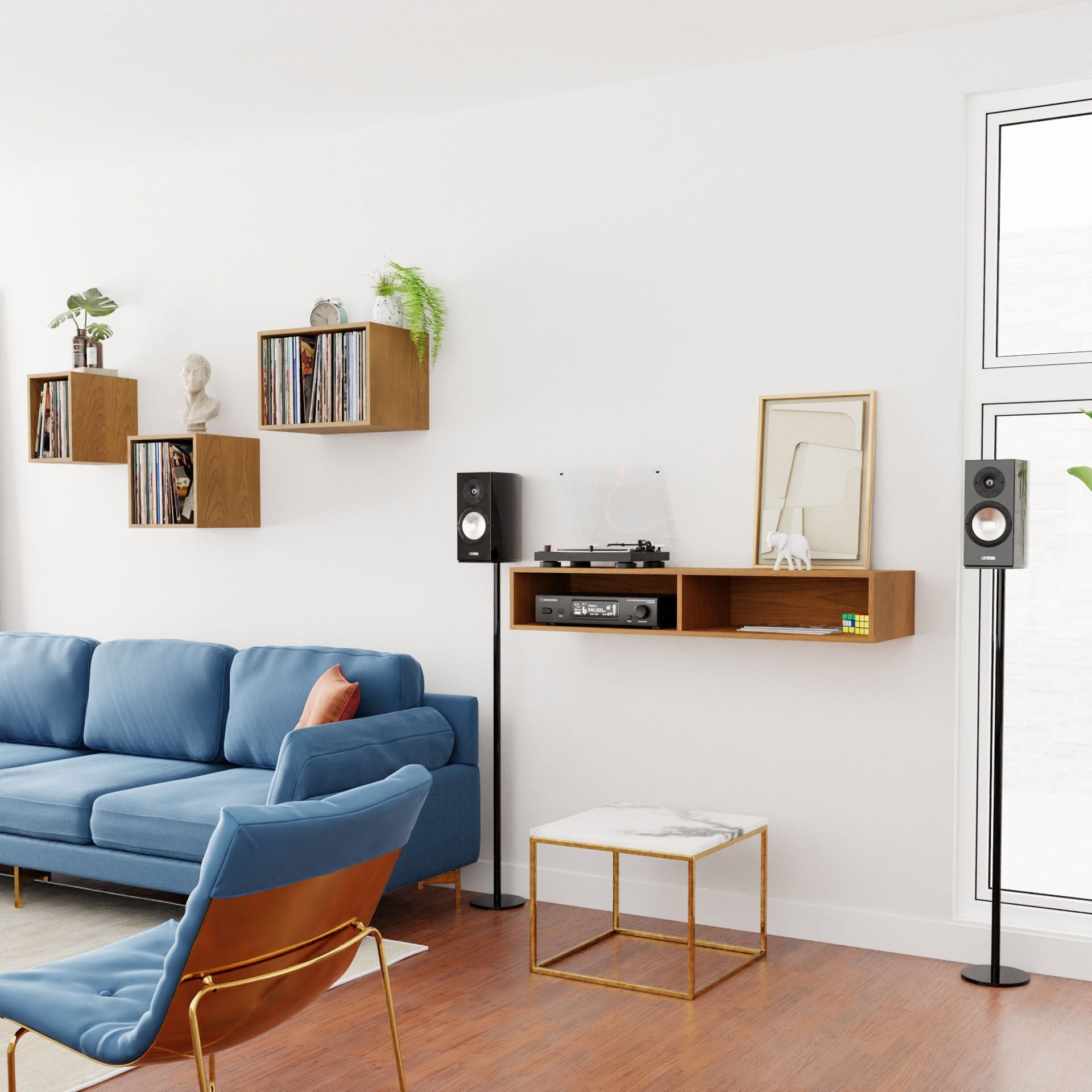 A mid-century modern living room featuring a blue sofa, wooden shelves holding vinyl records, and a record player on a wall-mounted shelf. Tall speakers stand beside an armchair with a blue seat, while the Krovel Stereo Table in Cherry rests gracefully on the solid American Cherry floor.